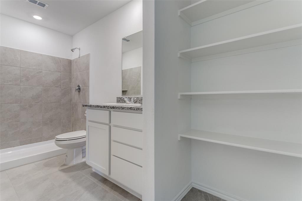 127 Sunflower Street Princeton, TX 75407 - Photo 17 of 21 Bathroom featuring tiled shower, toilet, tile floors, and vanity