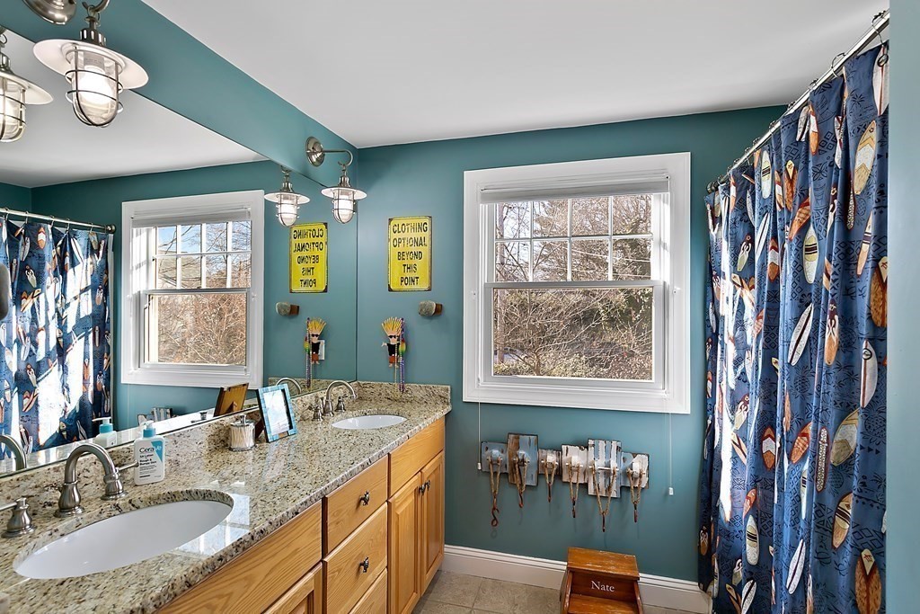 37 Gould Road Newton, MA 02468 - Photo 14 of 29 a bathroom with a granite countertop sink a large mirror and a window