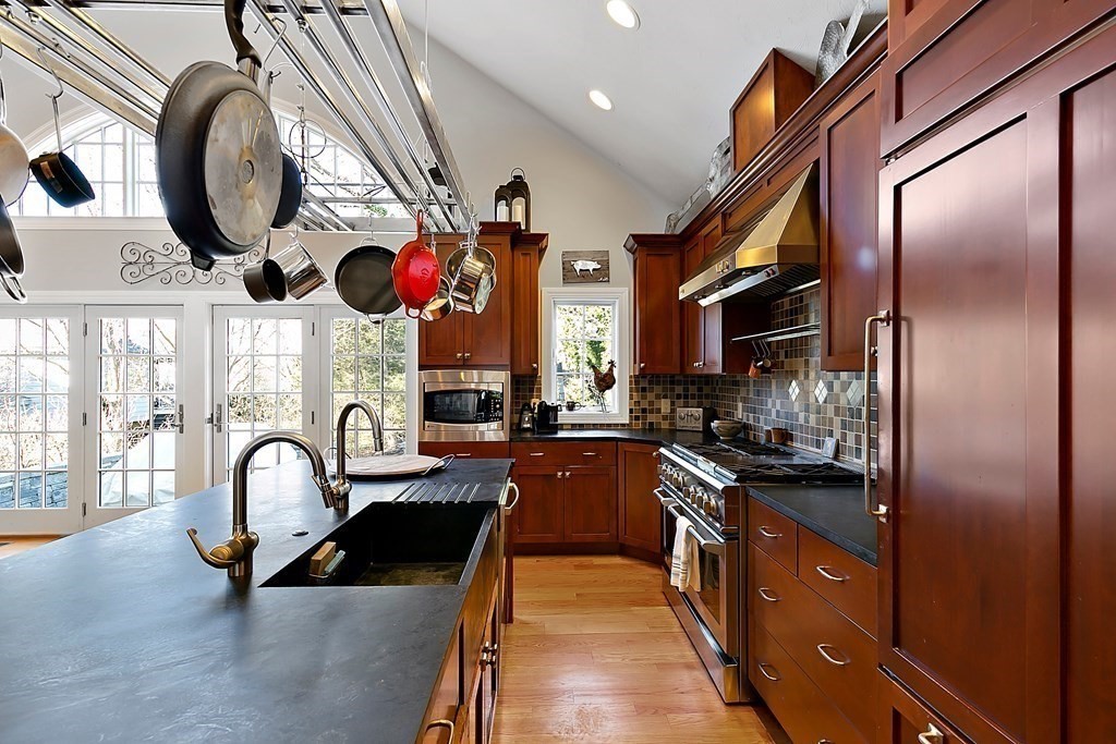 37 Gould Road Newton, MA 02468 - Photo 9 of 29 a kitchen with stainless steel appliances granite countertop a stove a sink and a refrigerator