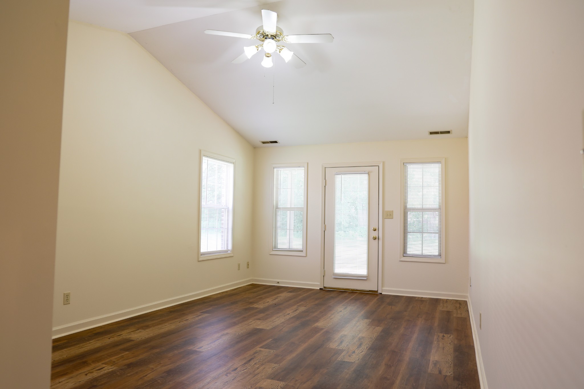 128 Bruce View Circle Hopkinsville, KY 42240 - Photo 4 of 13 an empty room with wooden floor ceiling fan and windows