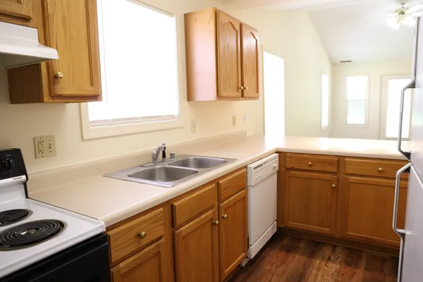 a kitchen with a sink stove and microwave