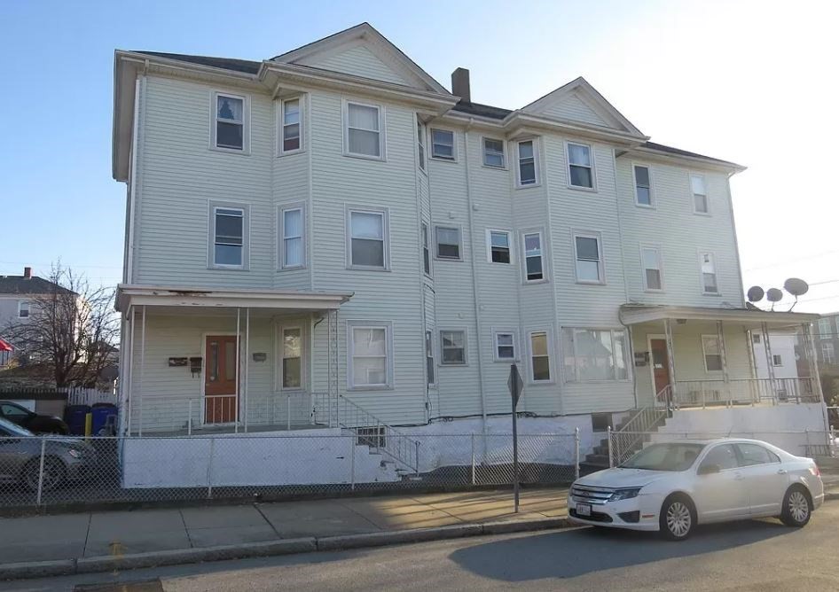 a view of a car parked in front of a building