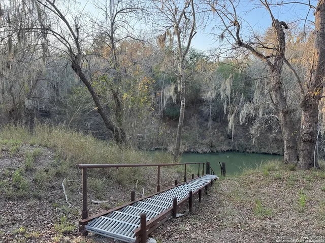 a view of a roof deck with wooden floor and fence