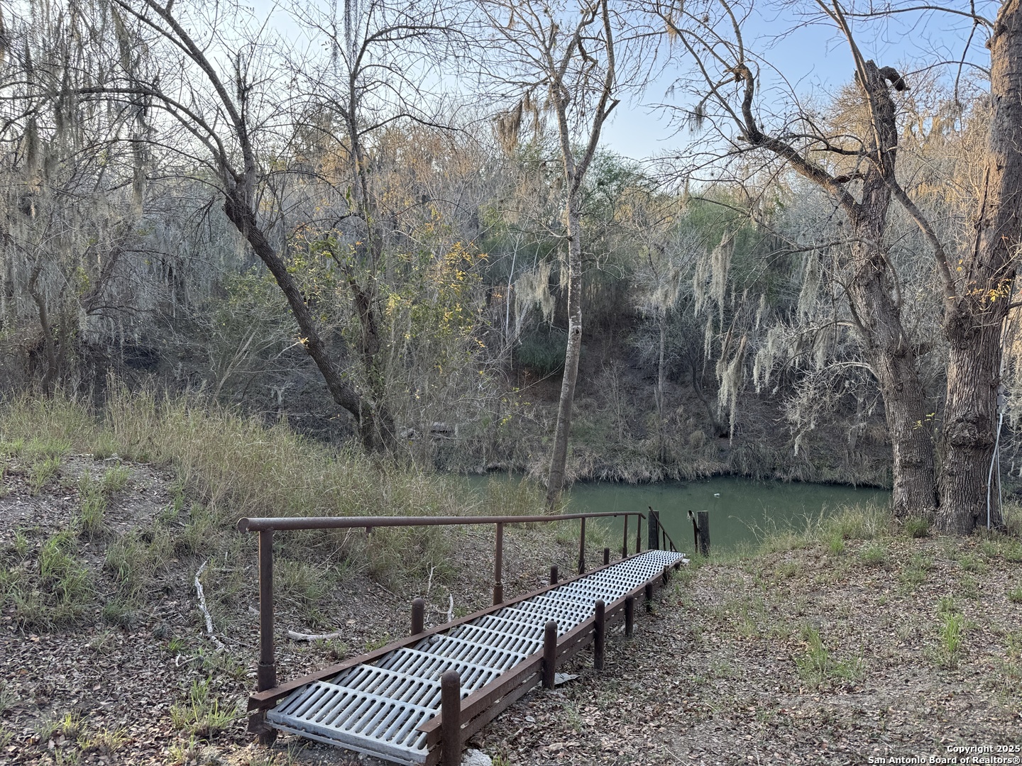 123 Choke Canyon Estates Drive Three Rivers, TX 78071 - Photo 16 of 19 a view of a roof deck with wooden floor and fence