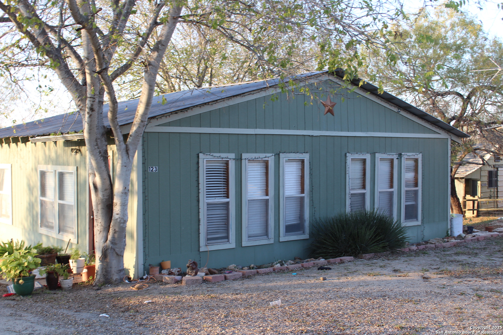 123 Choke Canyon Estates Drive Three Rivers, TX 78071 - Photo 6 of 19 a front view of a house with garden