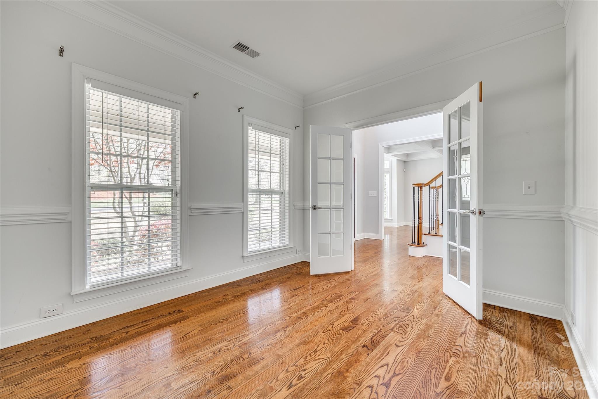 16420 Woolwine Road Charlotte, NC 28278 - Photo 11 of 41 a view of empty room with wooden floor and fan