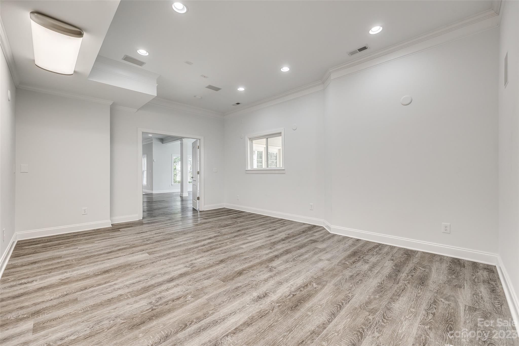 16420 Woolwine Road Charlotte, NC 28278 - Photo 19 of 41 an empty room with wooden floor and windows