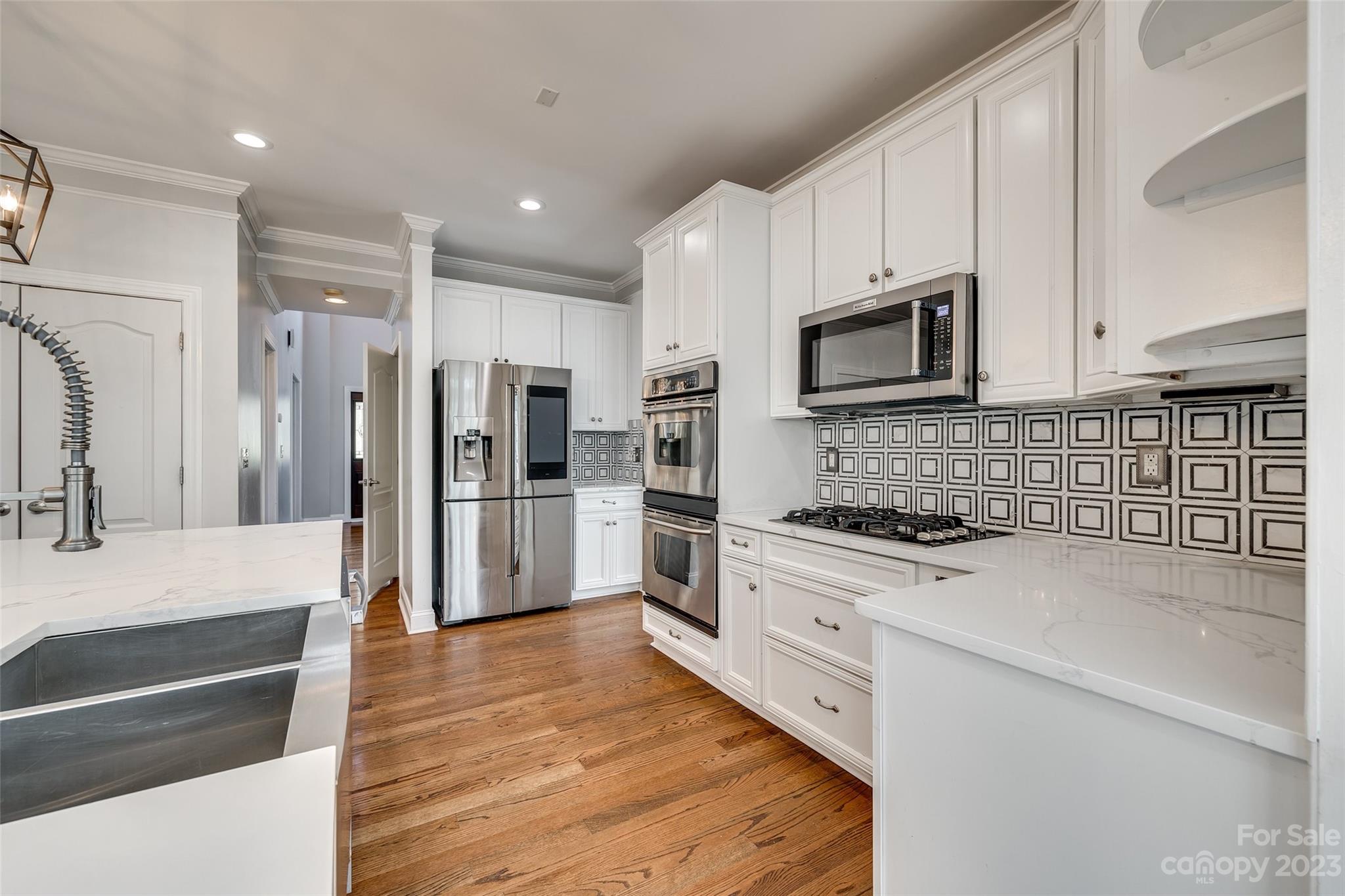 16420 Woolwine Road Charlotte, NC 28278 - Photo 9 of 41 a large kitchen with stainless steel appliances granite countertop a stove a sink and a refrigerator