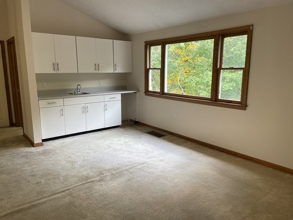 811 Washington Street, Unit 9 Pembroke, MA 02359 - Photo 4 of 10 a kitchen with a stove a sink and a window