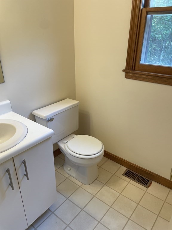 811 Washington Street, Unit 9 Pembroke, MA 02359 - Photo 8 of 10 a white toilet sitting next to a bathroom sink
