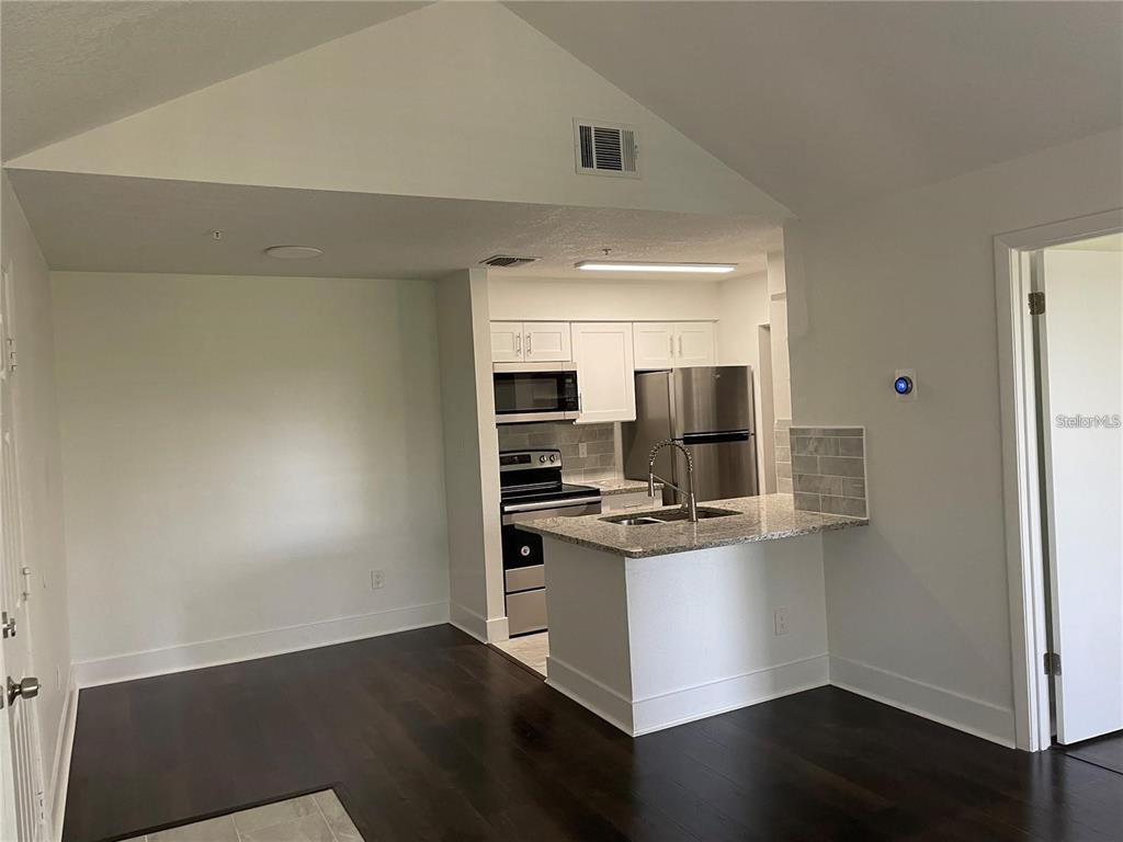 199 Afton Square, Unit 309 Altamonte Springs, FL 32714 - Photo 7 of 17 a kitchen with stainless steel appliances a sink and a stove top oven