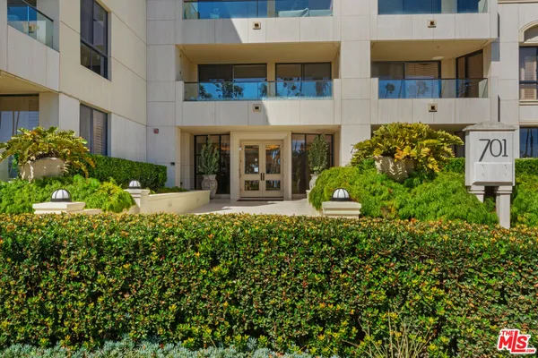 a view of a building with potted plants