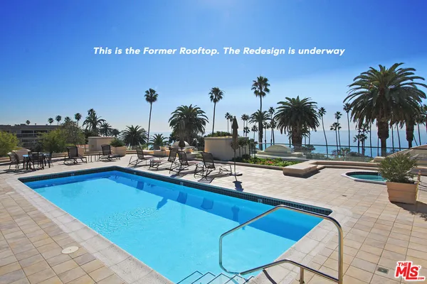 a view of a swimming pool and chairs