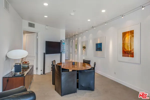 a living room with furniture a flat screen tv and a large window