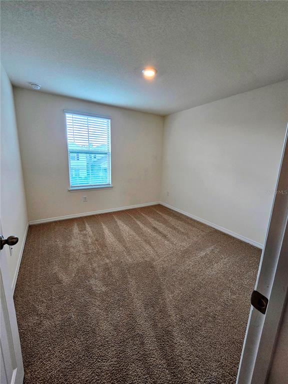 17101 Water Spring Boulevard Winter Garden, FL 34787 - Photo 13 of 29 an empty room with windows