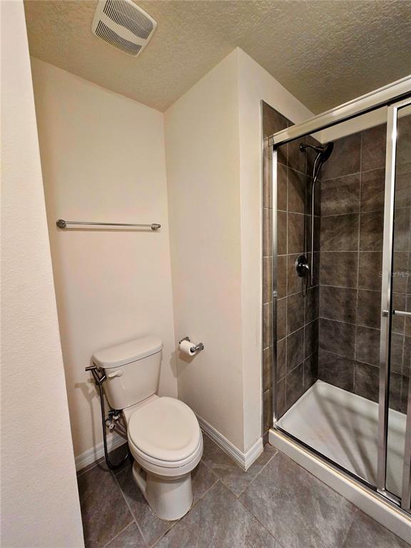 17101 Water Spring Boulevard Winter Garden, FL 34787 - Photo 26 of 29 a bathroom with a toilet and a shower