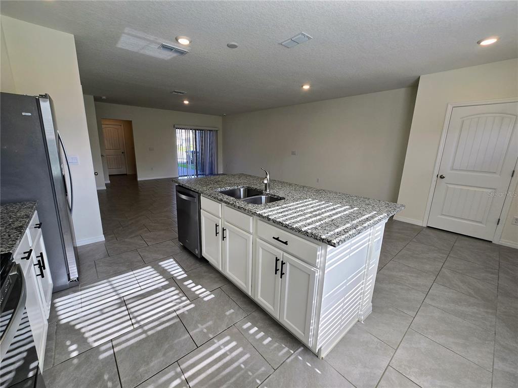 17101 Water Spring Boulevard Winter Garden, FL 34787 - Photo 4 of 29 a kitchen that has a lot of cabinets in it