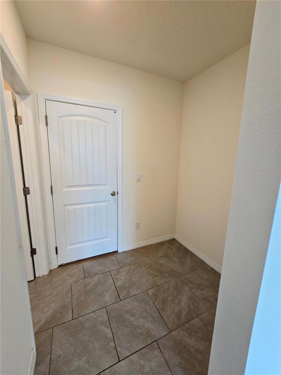 17101 Water Spring Boulevard Winter Garden, FL 34787 - Photo 8 of 29 an empty room with a wooden door
