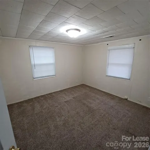 an empty room with a empty space and windows