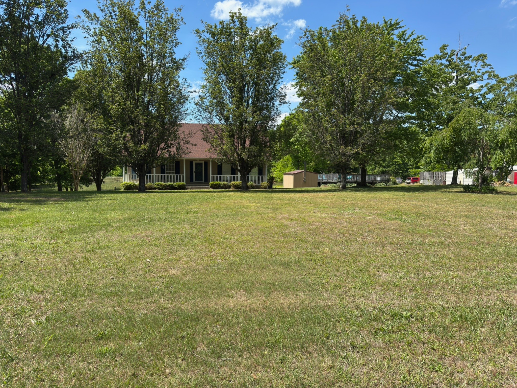 3594 Oak Grove Road Red Boiling Springs, TN 37150 - Photo 4 of 33 a front view of a house with a yard and trees