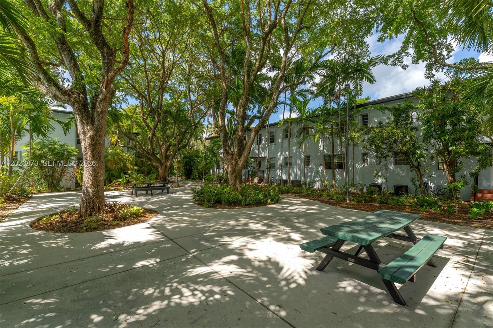 5590 Southwest 78th Street, Unit 133B Miami, FL 33143 - Photo 12 of 18 a view of a tree in the middle of a yard