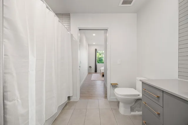 a bathroom with a double vanity sink mirror and bathtub