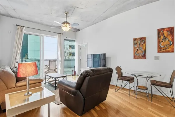 a living room with furniture and a flat screen tv