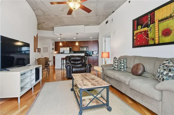 a living room with furniture a rug and a window