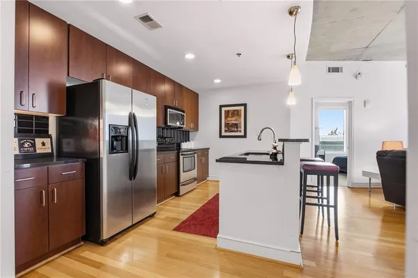a large kitchen with a table and chairs