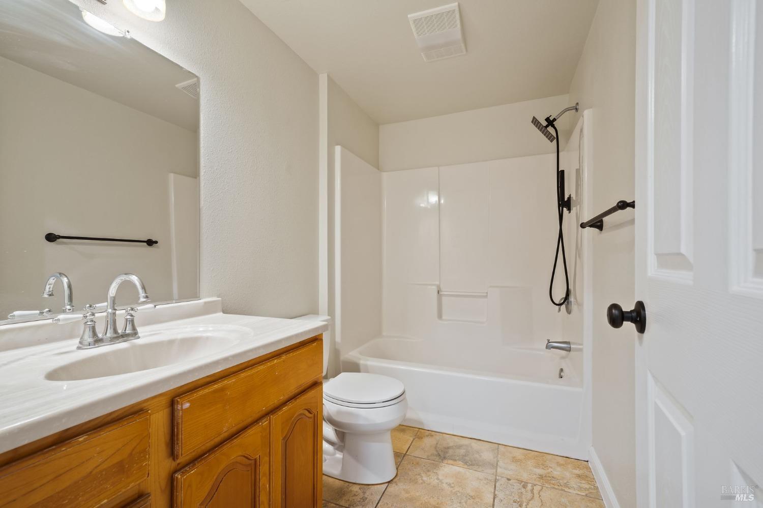 84 Front Street Camp Meeker, CA 95419 - Photo 16 of 24 a bathroom with a granite countertop sink toilet and shower