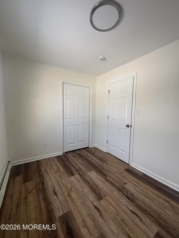 a view of an empty room and wooden floor