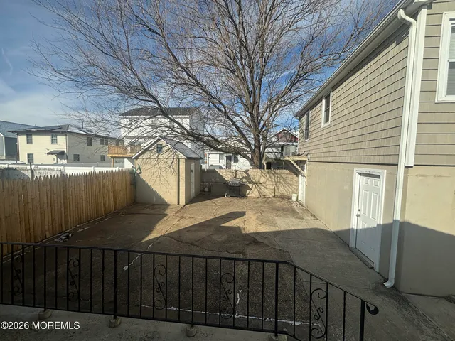 a view of a house with a wooden fence