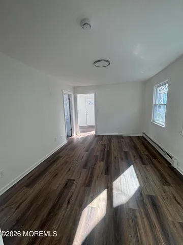 a view of wooden floor and windows in a room