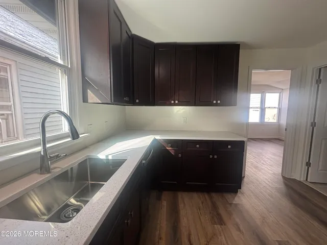 a kitchen with wooden cabinets and a sink