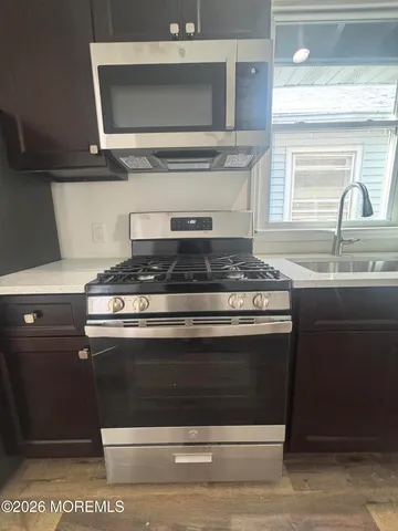 a stove top oven sitting inside of a kitchen