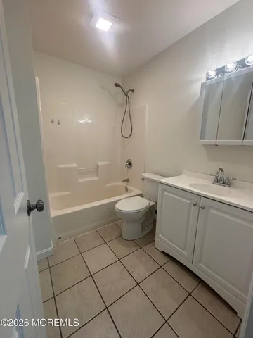a bathroom with a granite countertop sink a toilet and a mirror