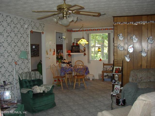 555 Nightingale Street Keystone Heights, FL 32656 - Photo 2 of 11 a view of a livingroom with furniture and a chandelier