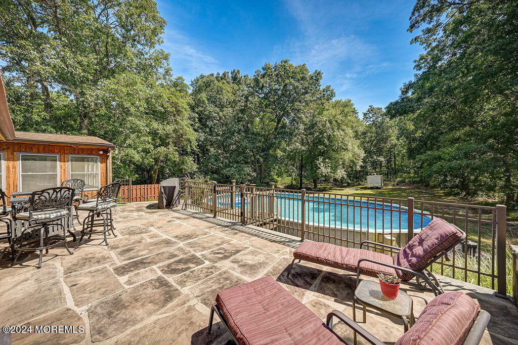 290 Easy Street Howell, NJ 07731 - Photo 41 of 43 a view of a patio with couches chairs and wooden floor