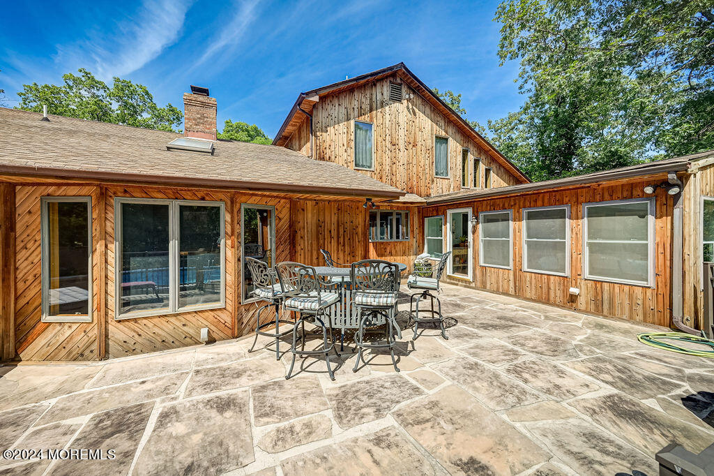 290 Easy Street Howell, NJ 07731 - Photo 43 of 43 a patio with table and chairs and potted plants