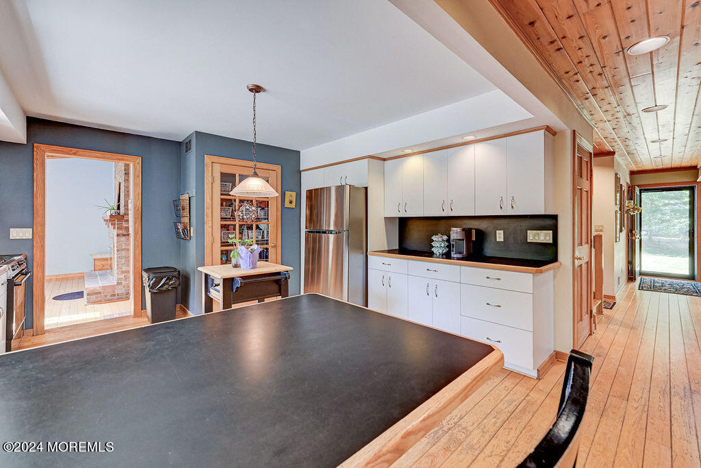 290 Easy Street Howell, NJ 07731 - Photo 10 of 43 a view of a kitchen with furniture and floor to ceiling window