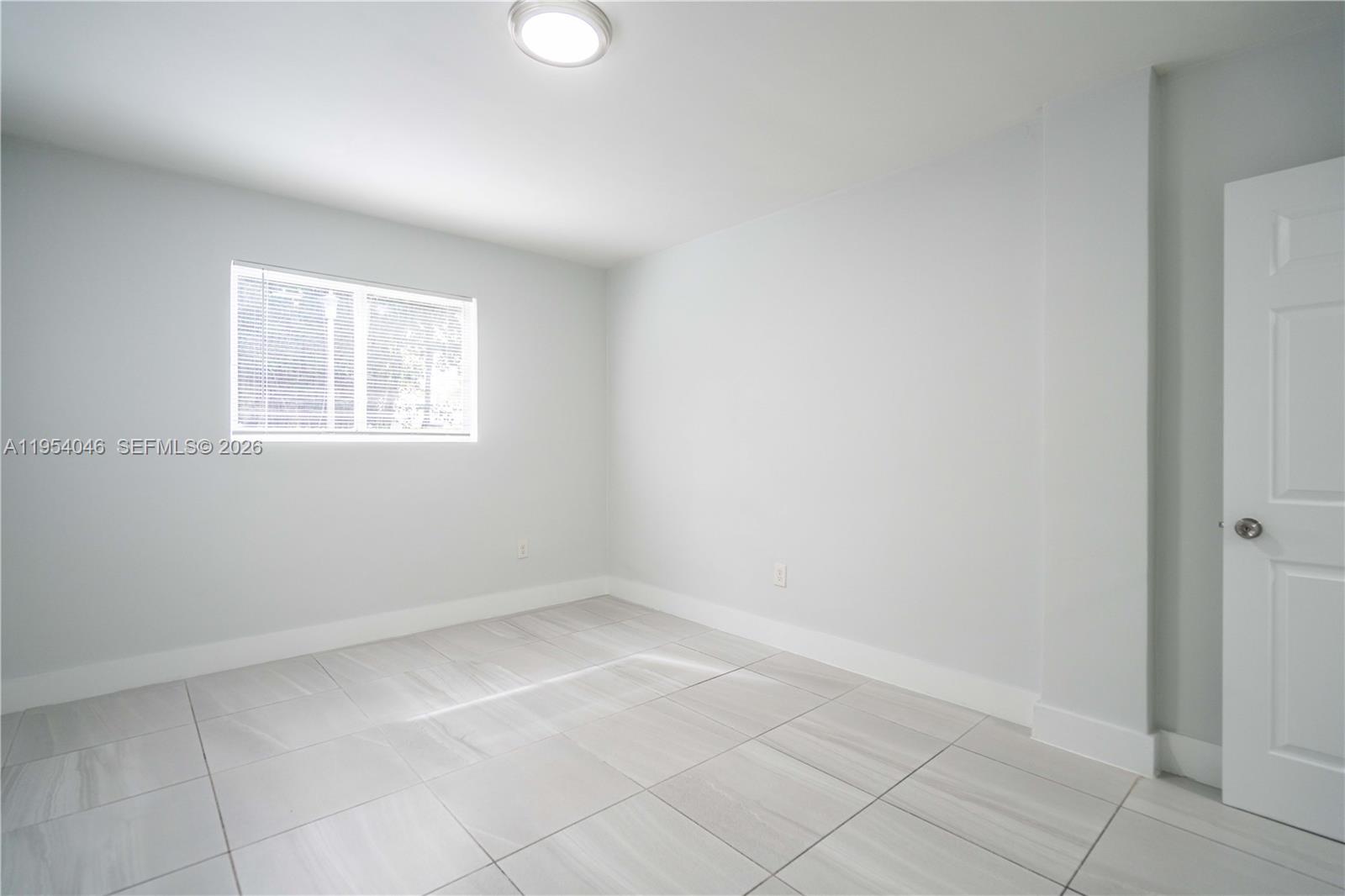 465 Northeast 59th Street, Unit 12 Miami, FL 33137 - Photo 14 of 17 an empty room with windows