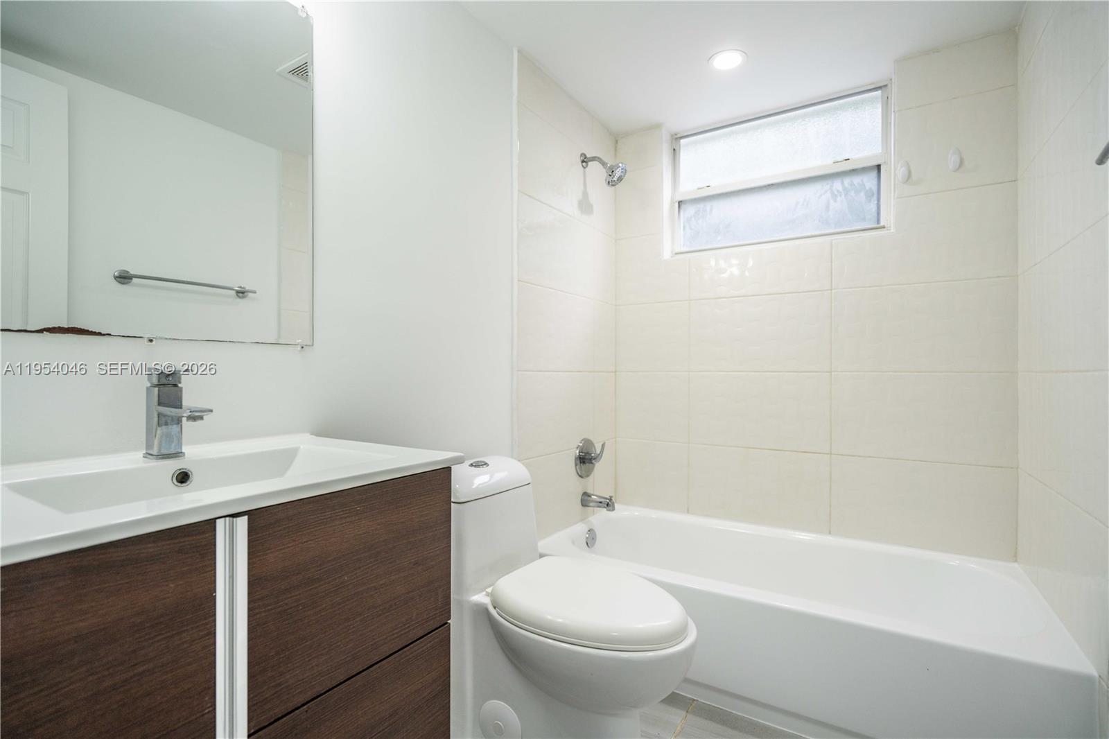 465 Northeast 59th Street, Unit 12 Miami, FL 33137 - Photo 15 of 17 a bathroom with a sink a toilet and shower