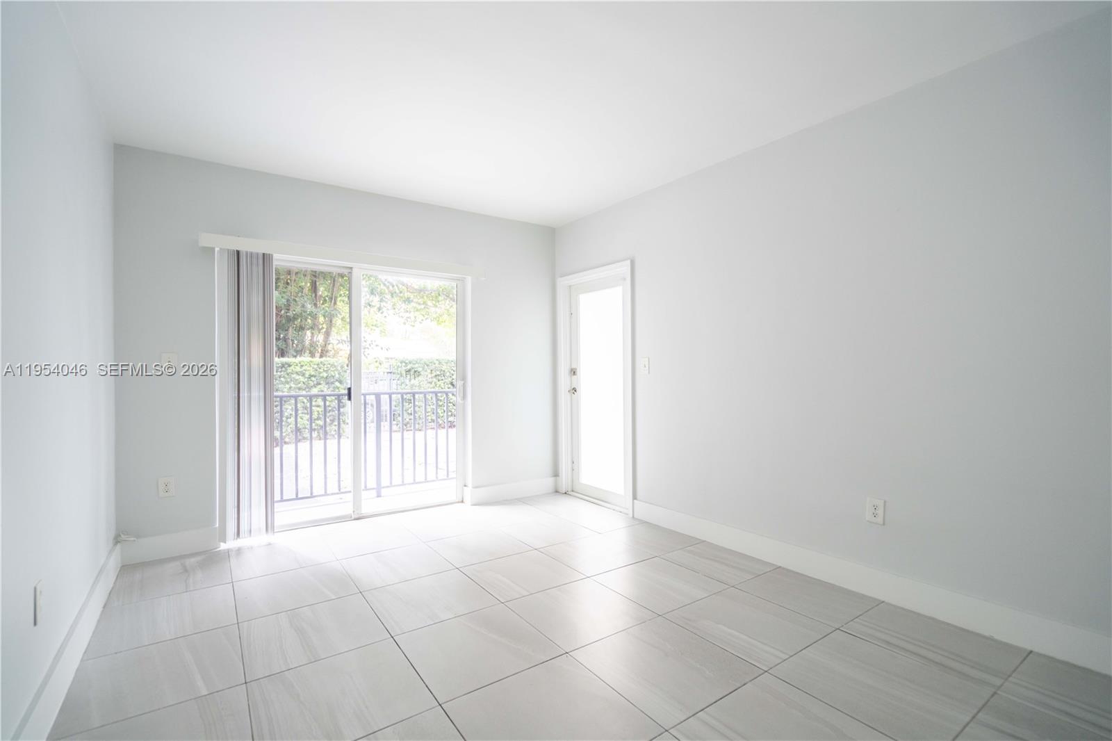 465 Northeast 59th Street, Unit 12 Miami, FL 33137 - Photo 4 of 17 a view of an empty room with a window