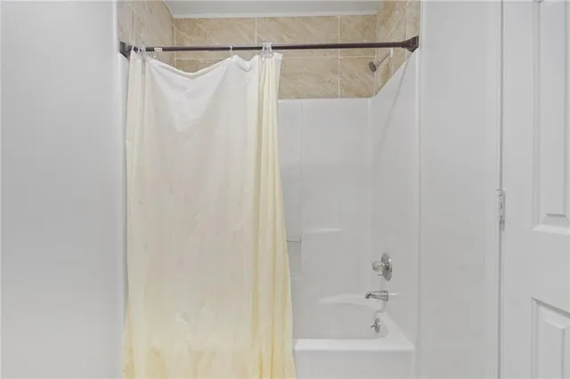 a bathroom with a shower and a bath tub