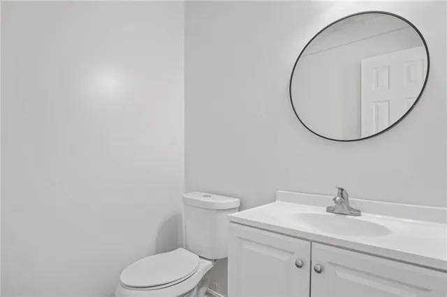 a white toilet sitting next to a bathroom sink
