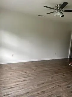 a view of a room with wooden floor