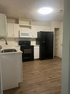 a kitchen with a refrigerator and a stove