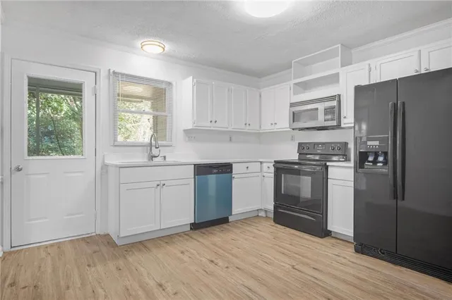 a kitchen with a refrigerator stove and sink