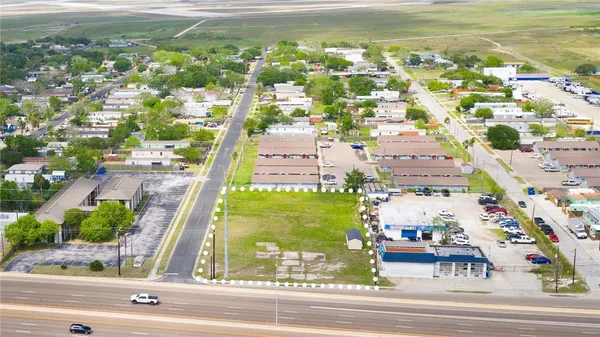 an aerial view of residential houses with outdoor space and parking