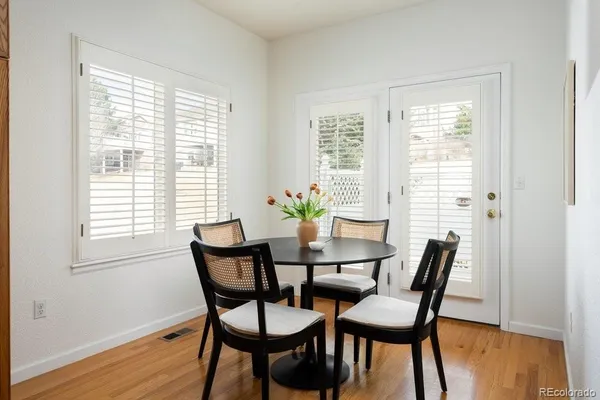 a view of a dining room with furniture and wooden floor